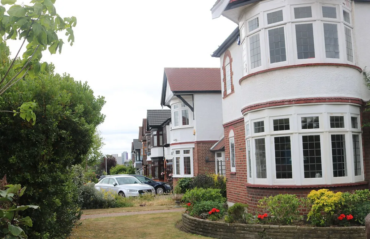 Bay-fronted semi-detached houses on a tree-lined street in Ilford