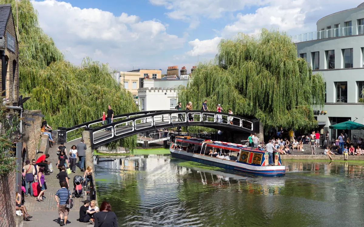 Narrowboats and crowds along a London canal